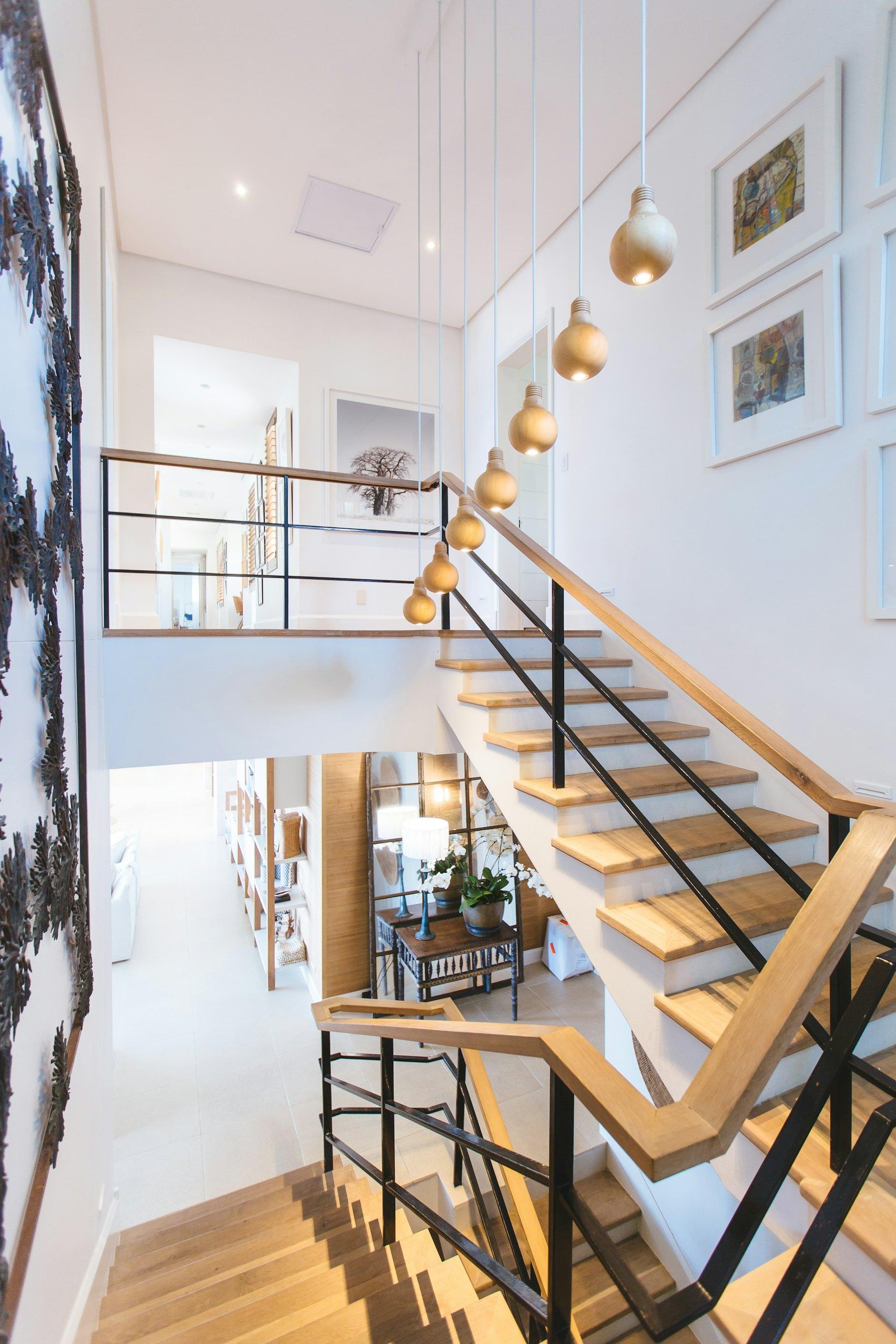 Sunlit entry staircase with natural wood treads